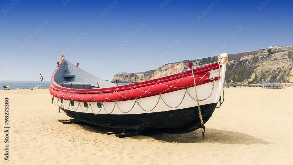 Fototapeta premium Boat on the beach in Nazare in Portugal