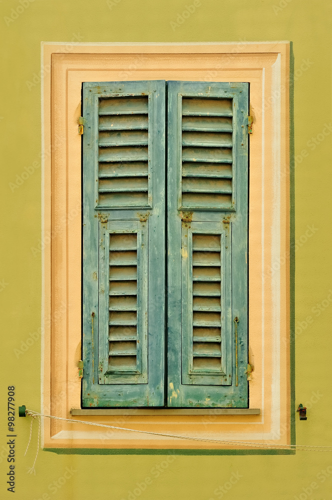 Fototapeta premium Old window shutters on the light green wall