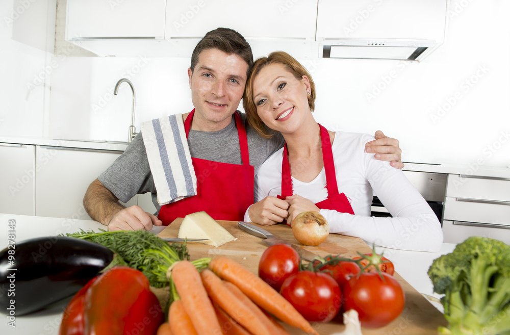 young beautiful couple working at home kitchen preparing vegetable salad together smiling happy young beautiful couple working at home kitchen preparing vegetable salad together smiling happy