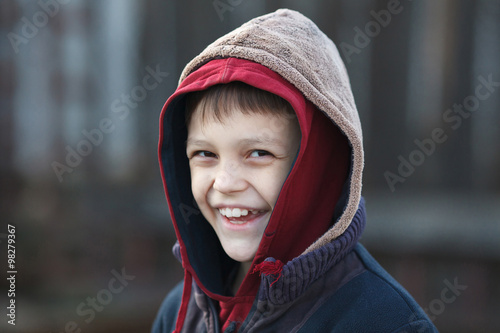 portrait of a little happy homeless boy