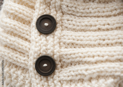 texture of white knitted soft sweater with buttons