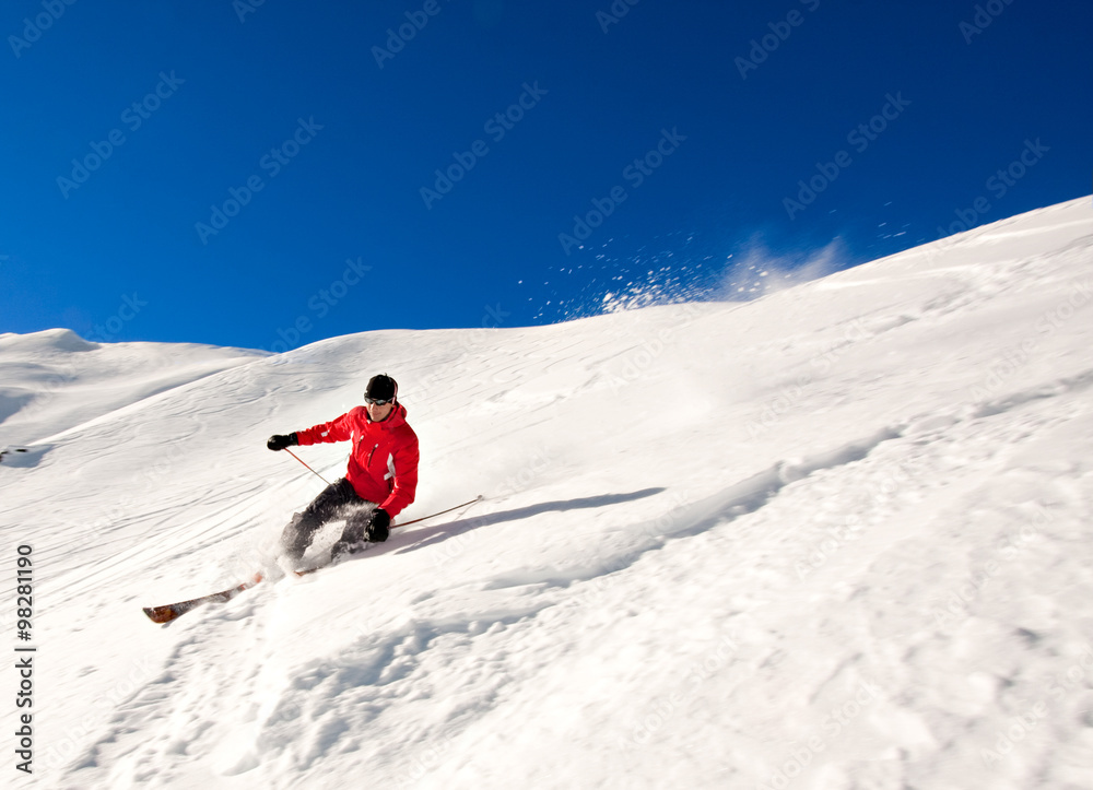 Young man skiing in powder snow