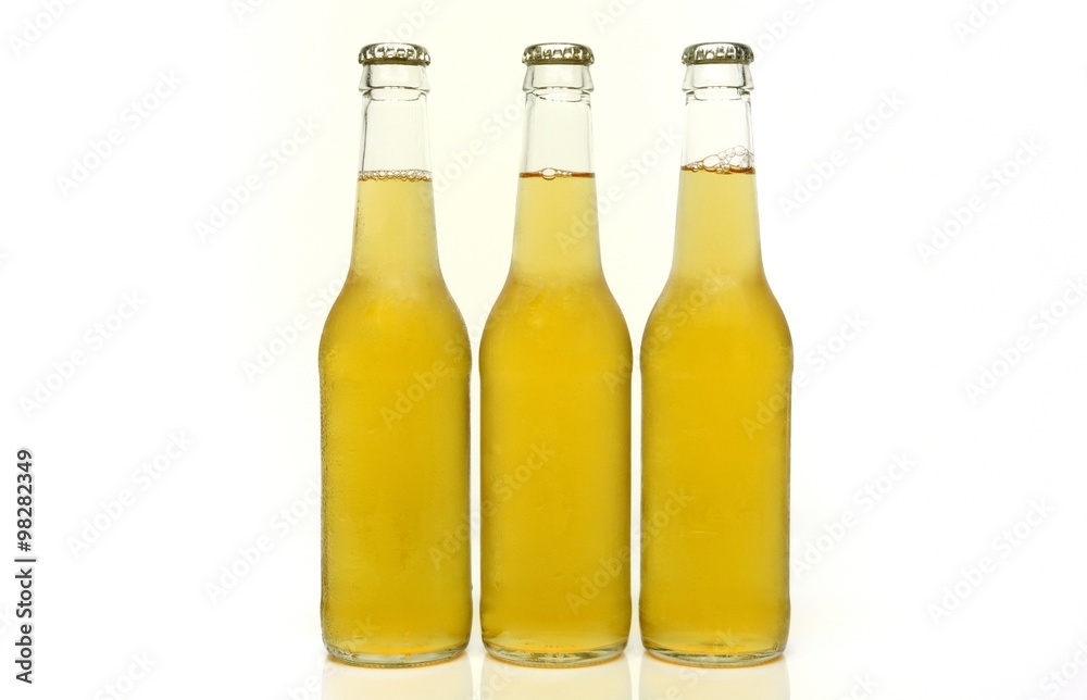 Three blank clear bottles of beer. Three blank clear bottles of beer.