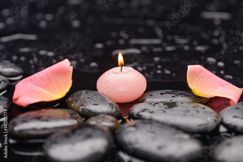  pink rose petals with candle and therapy stones 