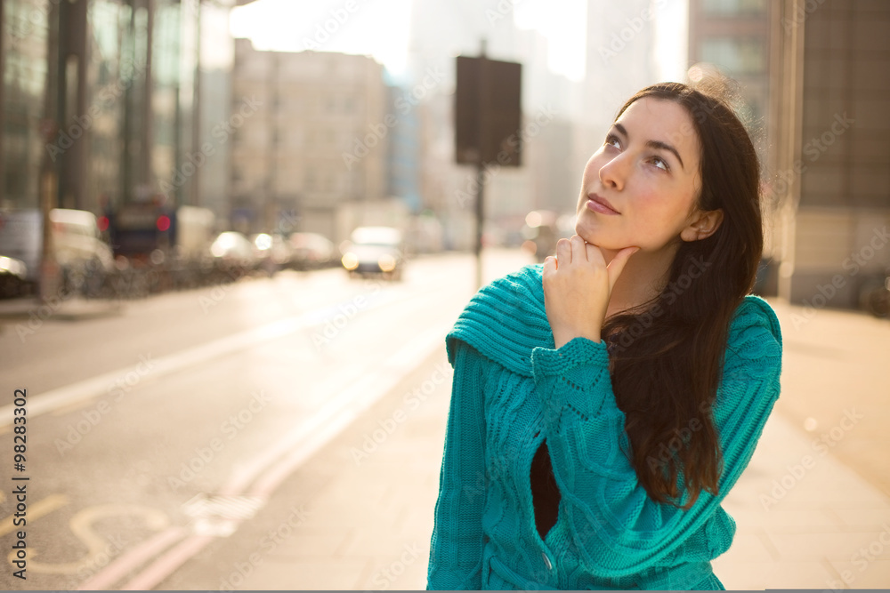 Fototapeta premium thoughtful young woman in the street