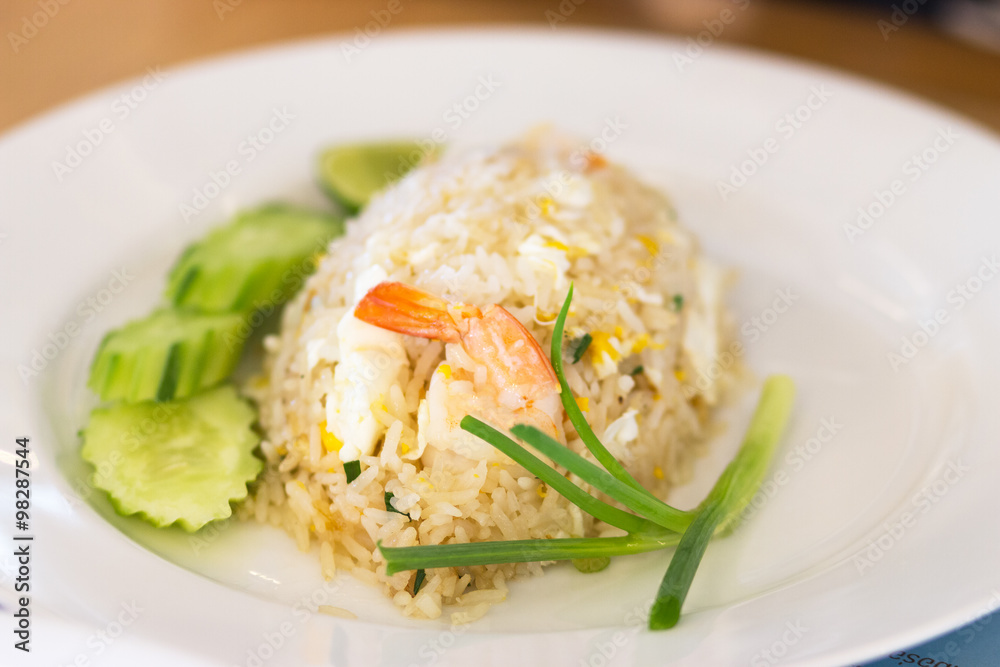 shrimp fried rice with cucumber and spring onions on a white pla shrimp fried rice with cucumber and spring onions on a white pla