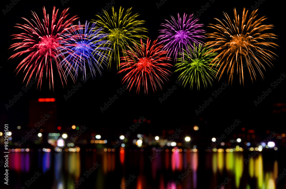 Fototapeta premium Fireworks celebration and the city night light background.
