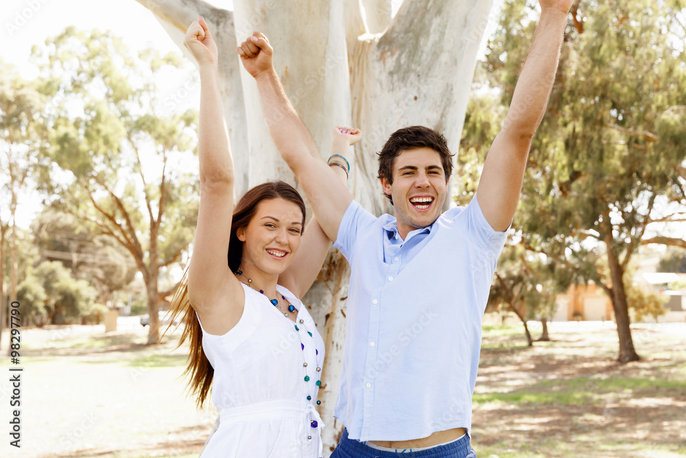Young couple in the park celebrating Young couple in the park celebrating