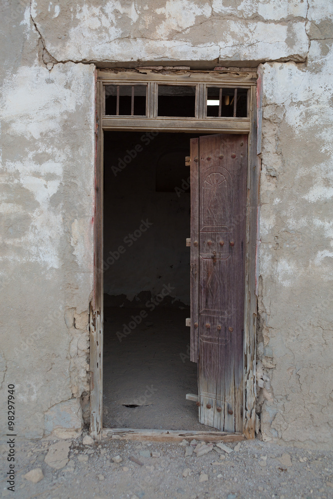 Traditional weathered wooden door frame, Old Ras Al Khaimah abandoned ghost town, Al Jazirah Al Hamra