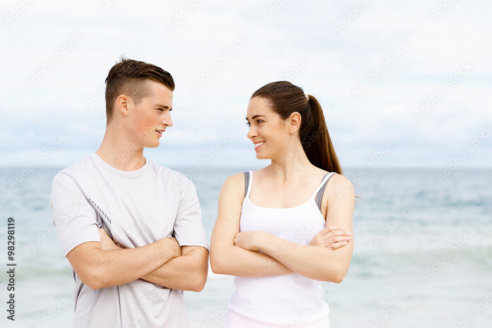 Fototapeta premium Young couple looking at each other on beach
