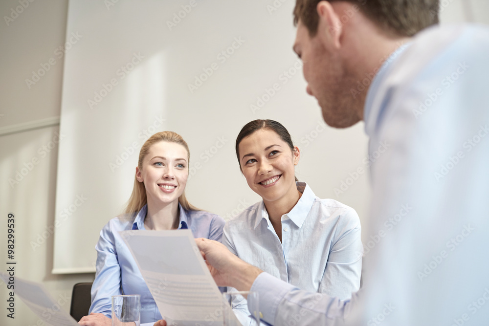 group of smiling businesspeople meeting in office group of smiling businesspeople meeting in office