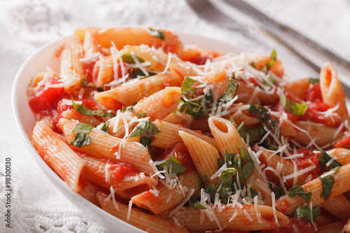 Arrabiata Pasta with Parmesan on a plate macro. horizontal 