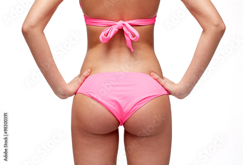 close up of young woman buttocks in pink bikini