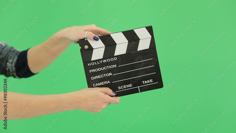 hand girl with clapperboard on the green screen
