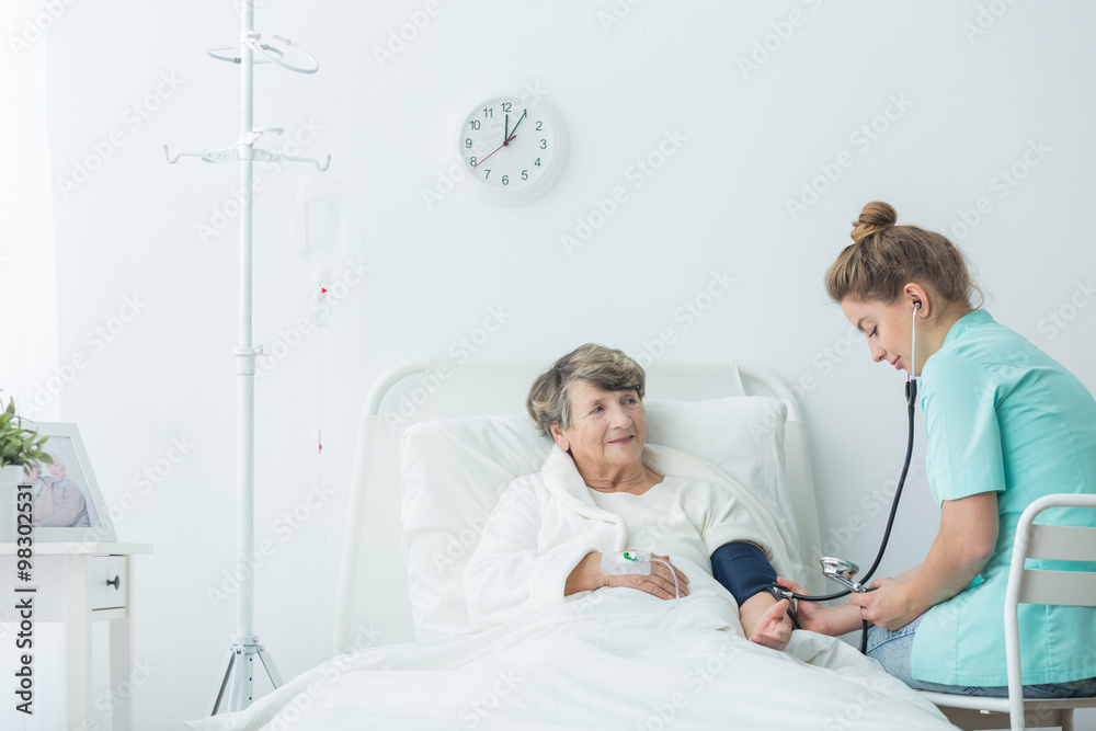 Fototapeta premium Carer measuring blood pressure