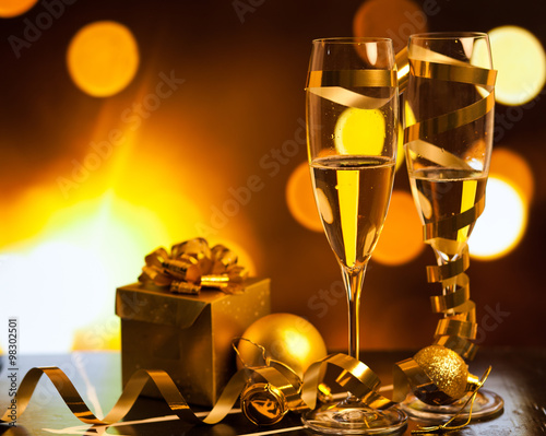 Toasting with champagne glasses against holiday lights