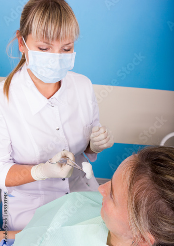 The reception was at the female dentist. Doctor examines the oral cavity on tooth decay.