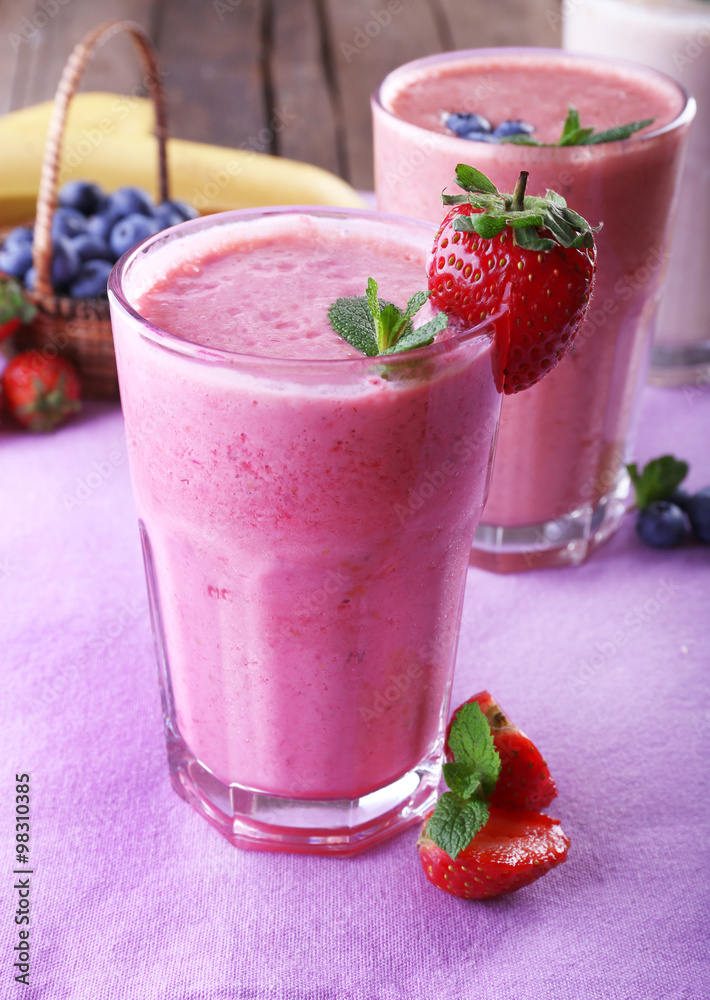 Glasses of fresh cold smoothie with fruit and berries, on the table, close-up Glasses of fresh cold smoothie with fruit and berries, on the table, close-up