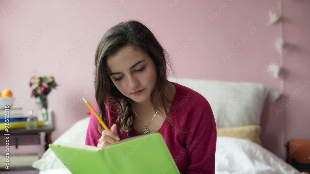 Teenage girl sitting in her room and writing her thoughts in the diary
Teenage girl sitting in her room and writing her thoughts in the diary