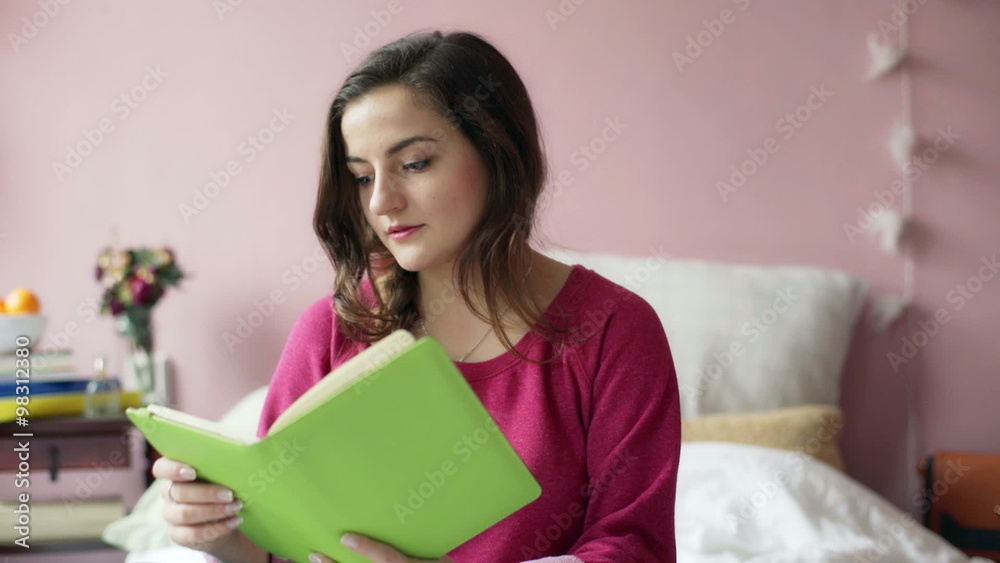 Teenage girl drinking orange juice and reading her thoughts in journal
Teenage girl drinking orange juice and reading her thoughts in journal