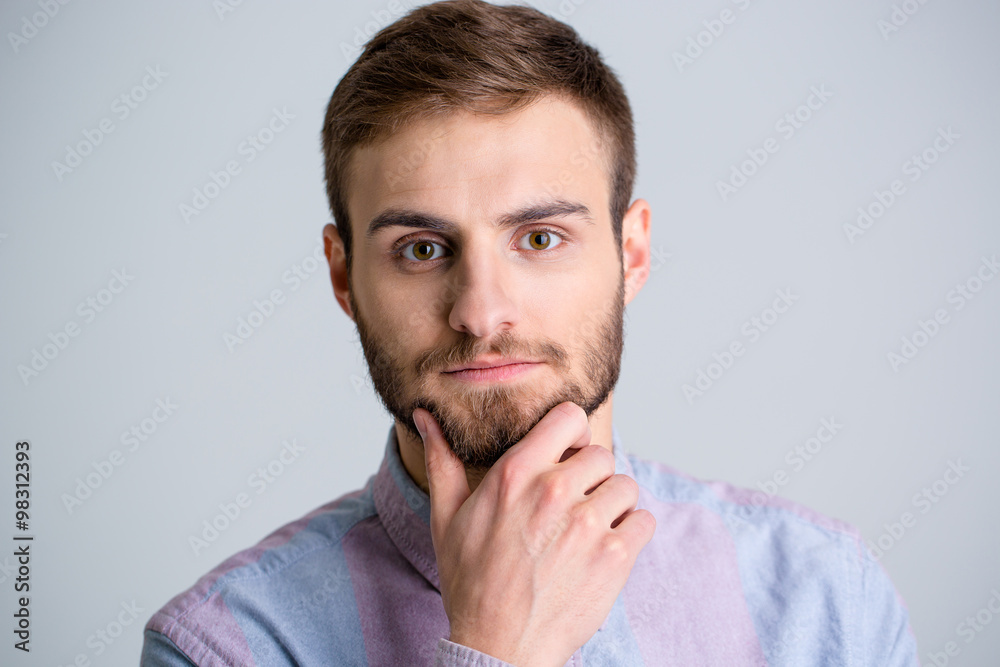 Portrait of handsome thoughtful young man with beard