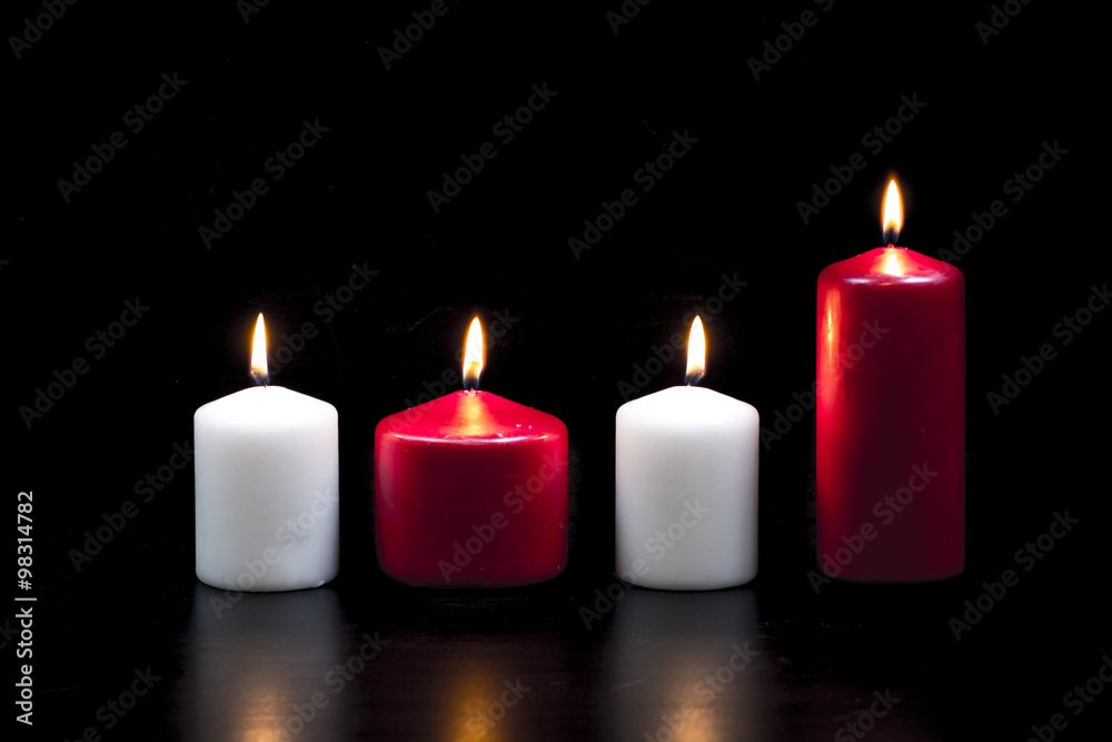 White and red candles on black background
