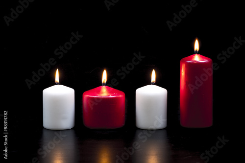 White and red candles on black background