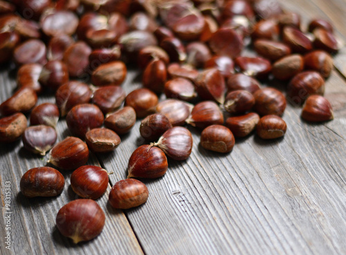 Fresh chestnut on wooden table closeup
