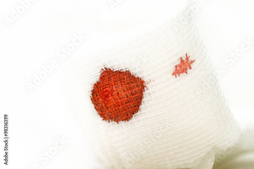 Gauze bandage with blood on white