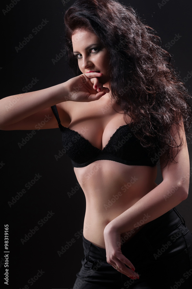 Fashion girl posing on dark background - portrait