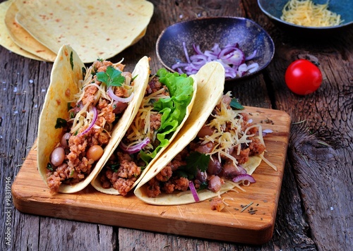tacos with minced meat with beans, cheese and onion
