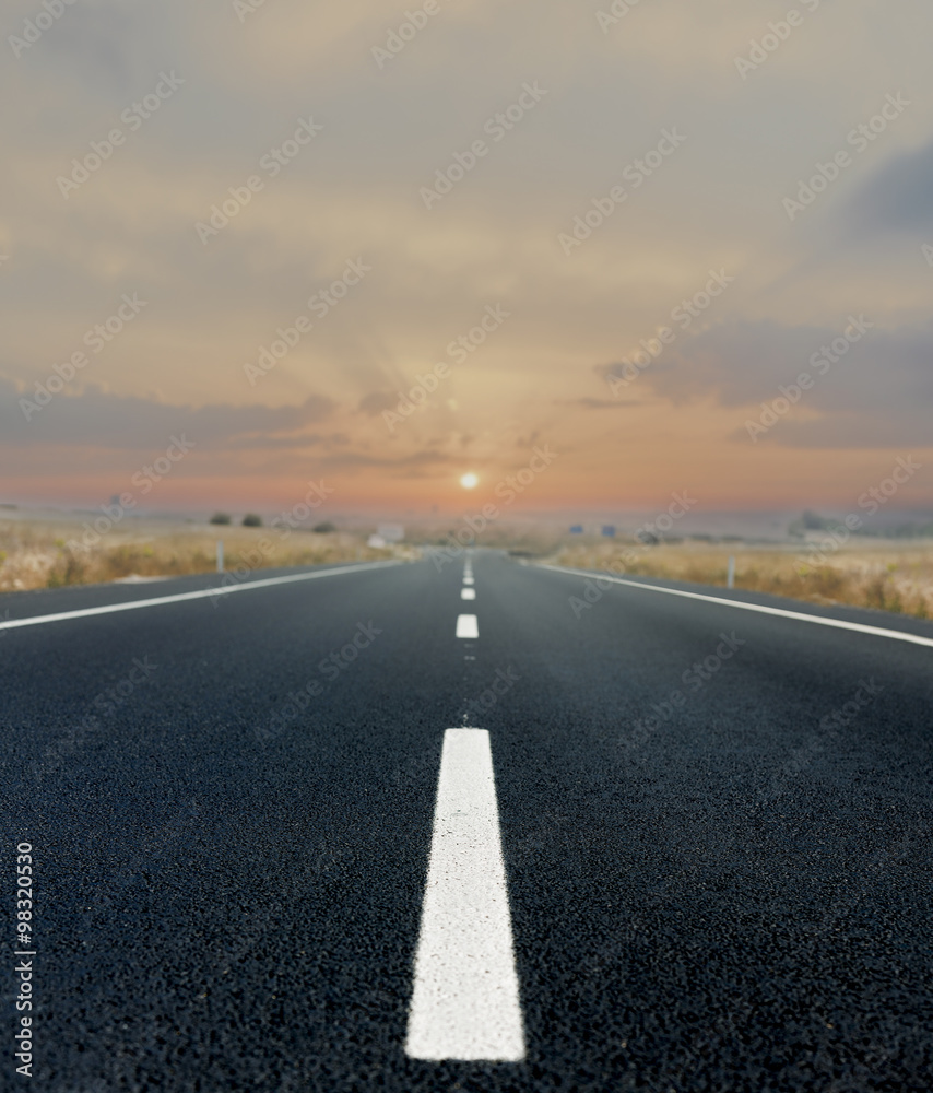 Fototapeta premium Asphalt road and the sunset
