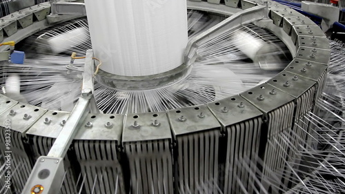 Textile industry - yarn spools on spinning machine in a factory