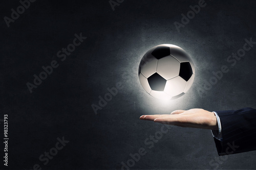 Fototapeta Naklejka Na Ścianę i Meble -  Soccer ball in palm
