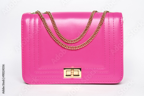 Pink lady's bag with a gold chain on a white background