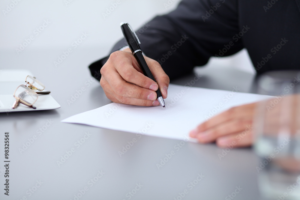 Close-up of male hands with pen over document, business concept Close-up of male hands with pen over document, business concept