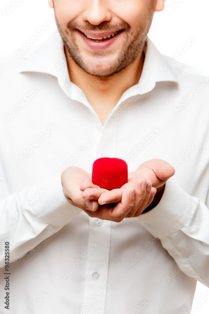 Young man presenting something in a small box Young man presenting something in a small box