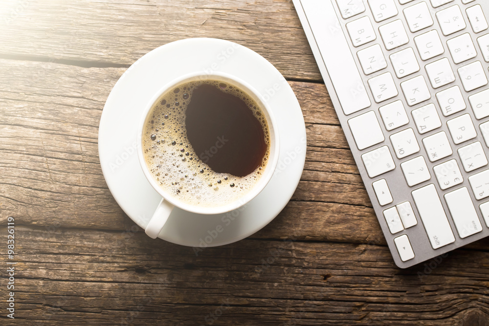 Keyboard, cup of coffee on a wooden background Keyboard, cup of coffee on a wooden background