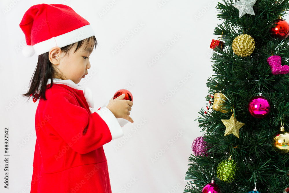 Asian Chinese little girl posing with Christmas Tree Asian Chinese little girl posing with Christmas Tree