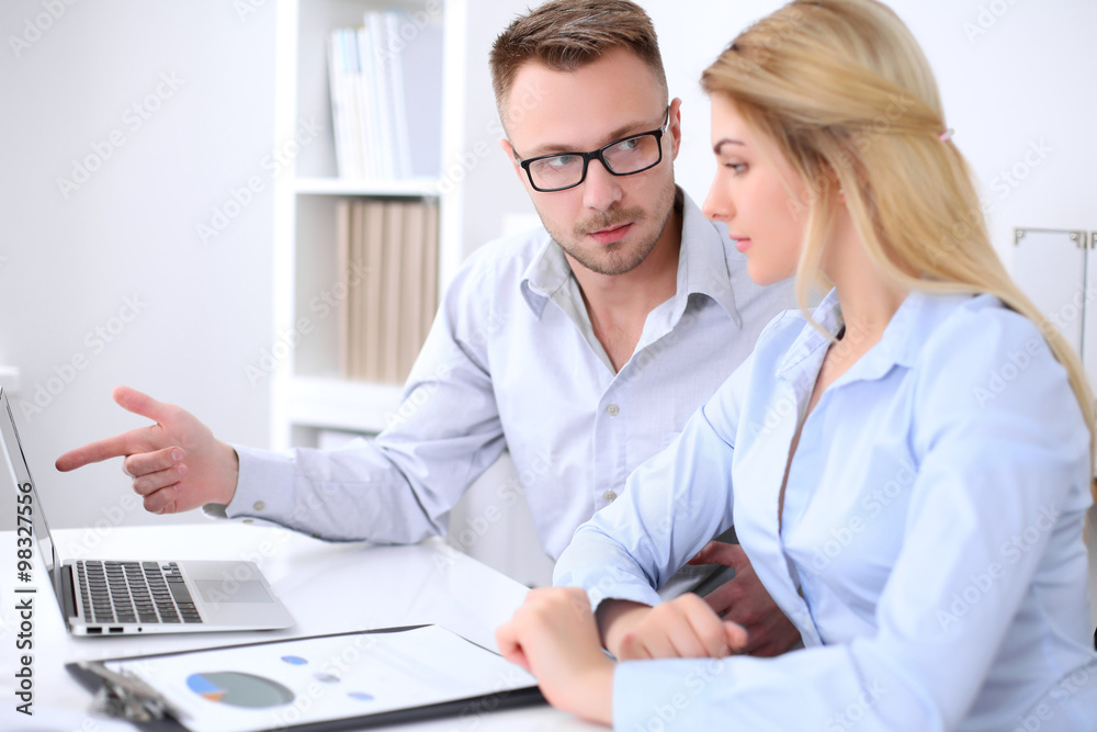 Two successful business partners working at meeting in office Two successful business partners working at meeting in office