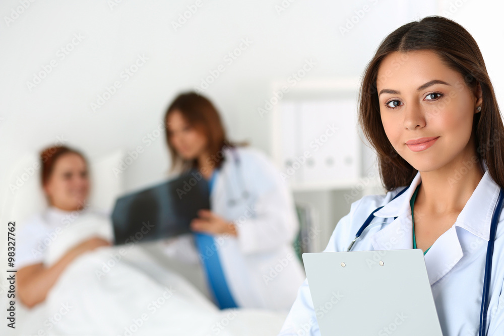 Beautiful female medicine doctor looking in camera Beautiful female medicine doctor looking in camera