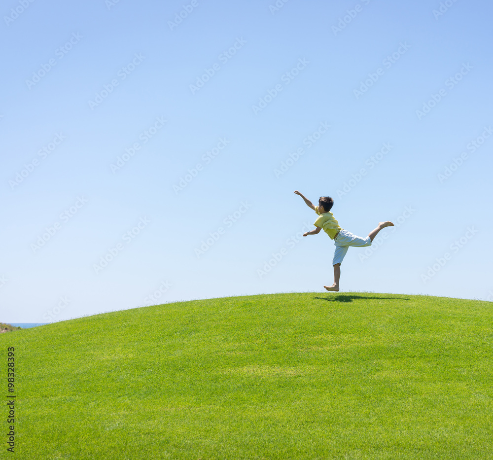 Kid jumping on beautiful field Kid jumping on beautiful field