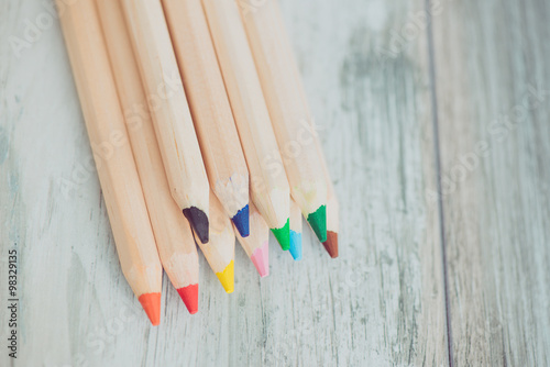 Assortment of colored pencils/Colored Drawing Pencils/Colored drawing pencils in a variety of colors on vintage wooden background