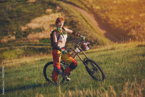 Extreme sports - young woman with downhill bike