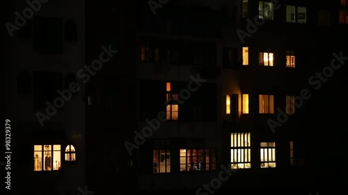 Iluminated window in a city building at night.