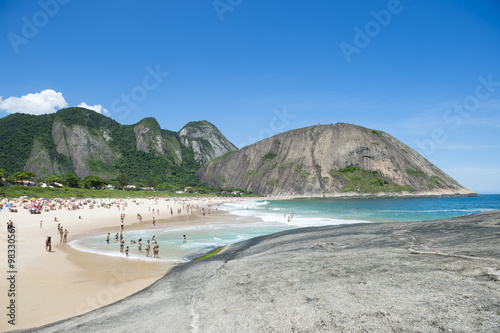 Bright view of Itacoatiara Beach from the dramatic rocks of the sea-facing beach in Niteroi, popular with surfers and bodyboarders, in Rio de Janeiro, Brazil 