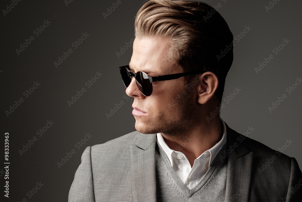 Confident sharp dressed man in black suit