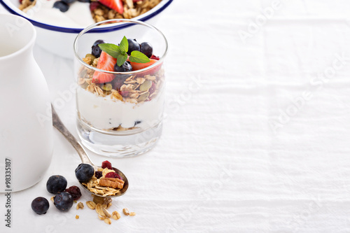 Granola with fresh berries in a blue bowl