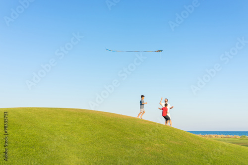 Running with kite on summer holiday vacation  perfect meadow and