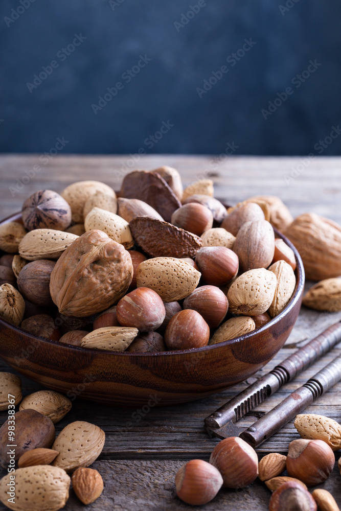 Variety of nuts with shells in a bowl Variety of nuts with shells in a bowl